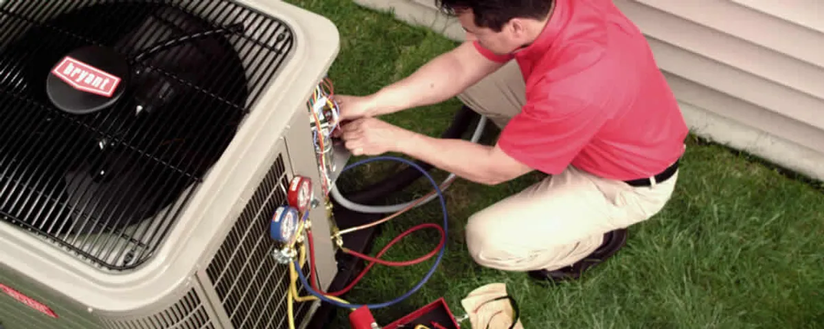HVAC technician servicing an outdoor air conditioner unit in Colorado Springs, CO